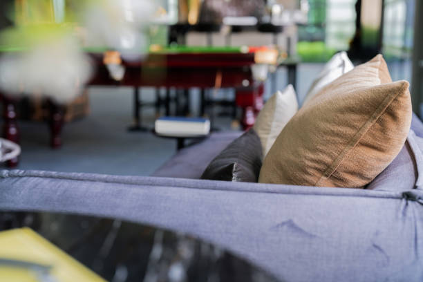 Cozy seating features colorful pillows adding charm to the cafe atmosphere.