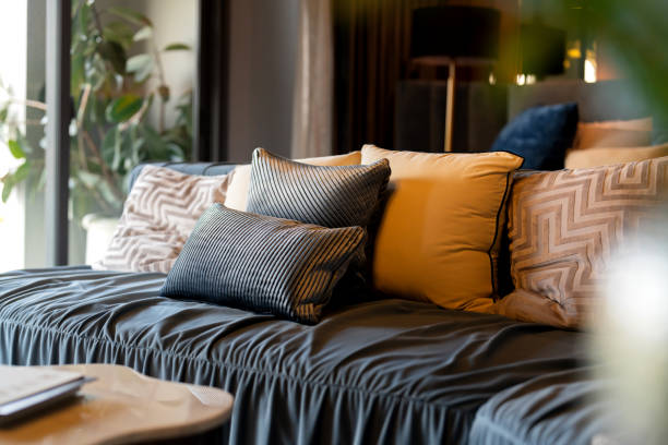 A modern designed sofa Pillows And Cushions On Sofa Stylish colorful cushions on couch in living room