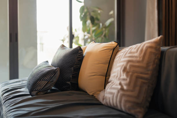 A modern designed sofa Pillows And Cushions On Sofa Stylish colorful cushions on couch in living room