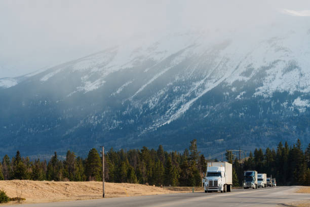 istock Truck on highway through  Canadian Rockies in spring 2183305523
