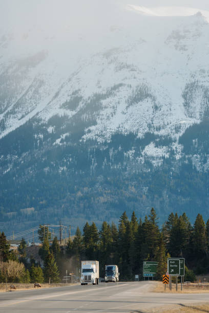 istock Truck on highway through  Canadian Rockies in spring 2183305524