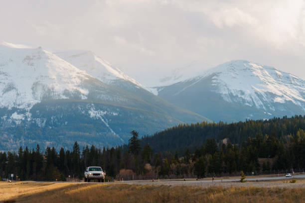 istock Car  on highway through Canadian rockies  at sunset 2183305693