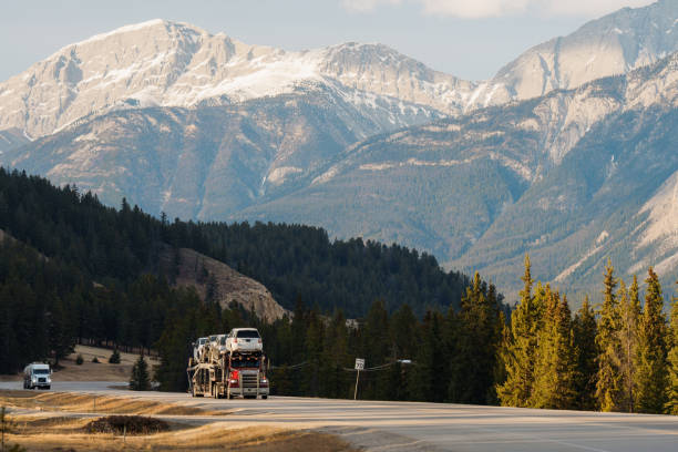 istock Truck on highway through  Canadian Rockies in spring 2183305876