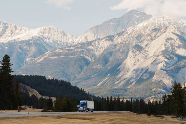 istock Truck on highway through  Canadian Rockies in spring 2183306178