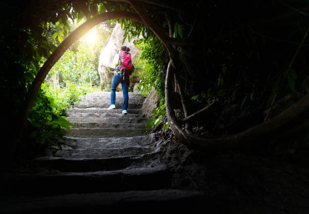 Woman climbing stairs up the mountain