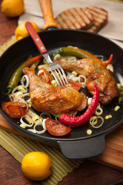 Roasted chicken in iron frying pan