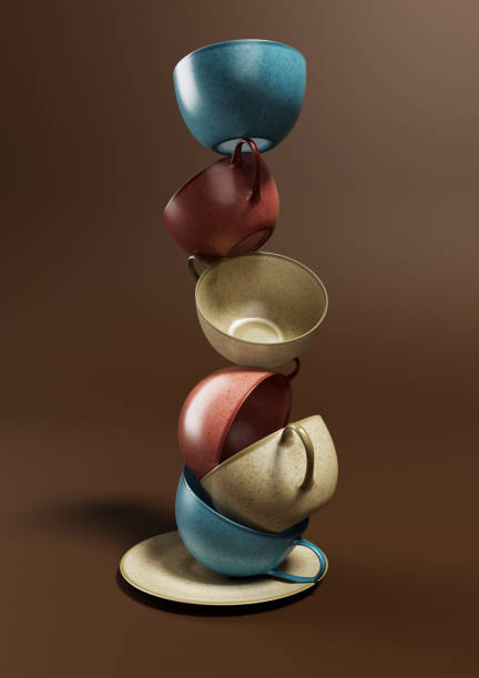 Teacups balanced on each other isolated on brown