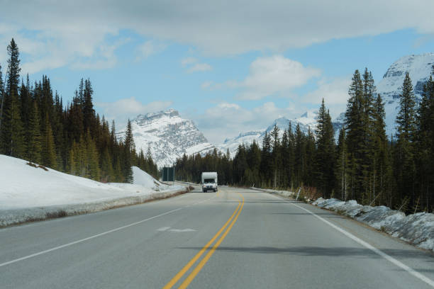 istock Truck on highway through  Canadian Rockies in spring 2183311319