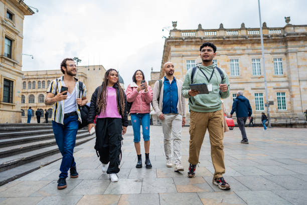 istock Tour guide using digital tablet and walking with tourists in Bogota 2183312462