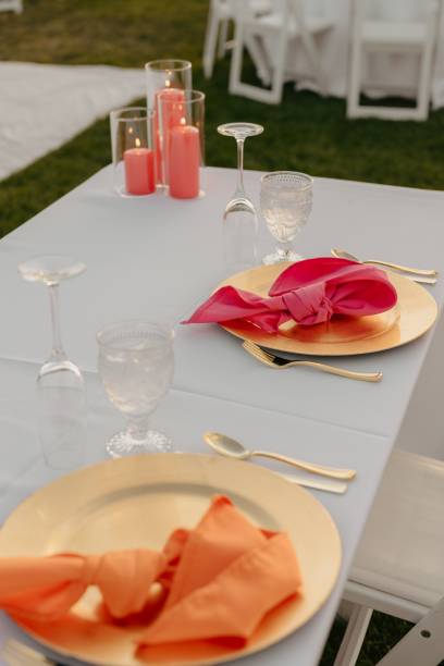 istock Wedding table decorated with red and orange accents and a white tablecloth 2183314532
