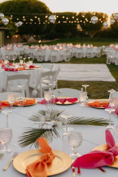 istock Wedding table decorated with red and orange accents and a white tablecloth 2183314542