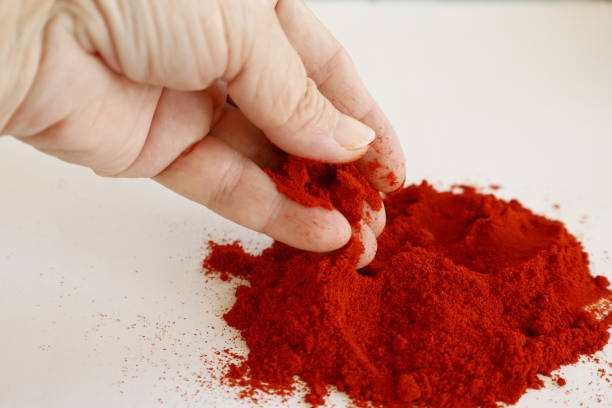 istock hand holding red paprika powder 2183315201