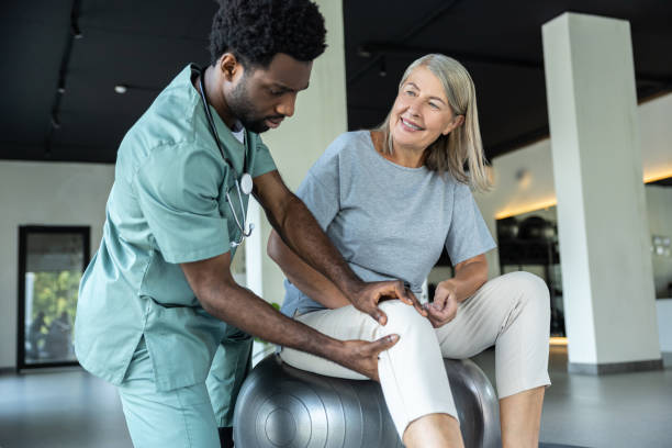 istock African american manual therapist working with a female patient with problematic joints 2183318580