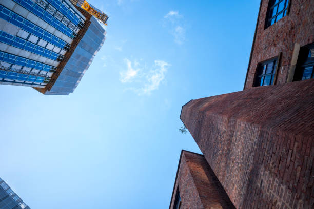 istock Modern and old, contrasting architecture against a bright blue sky. 2183318694