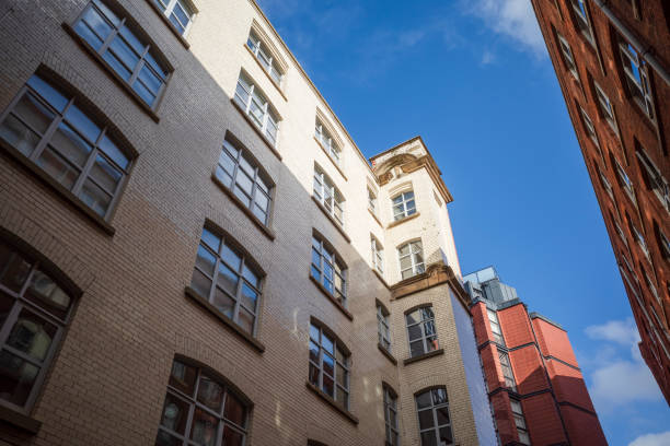 istock Urban architecture built with white bricks with sunlight casting shadows on buildings. 2183318753