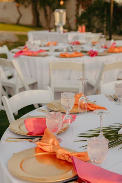 istock Wedding table decorated with red and orange accents and a white tablecloth 2183320120