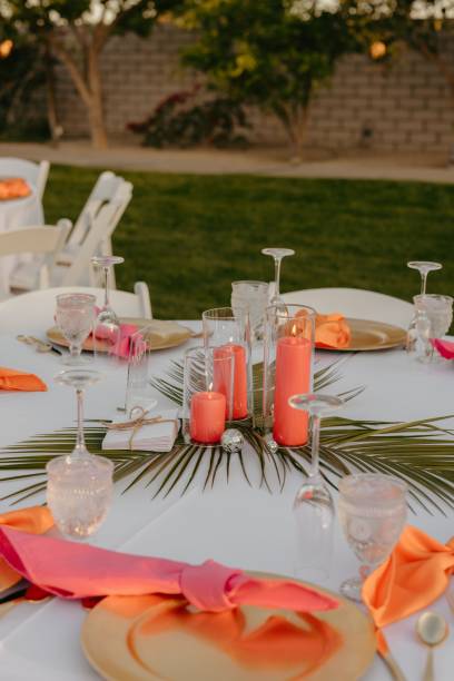 istock Wedding table decorated with red and orange accents and a white tablecloth 2183320135