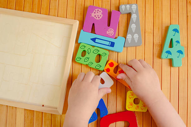 istock Child playing with wooden numbers Intelligence game 2183321143