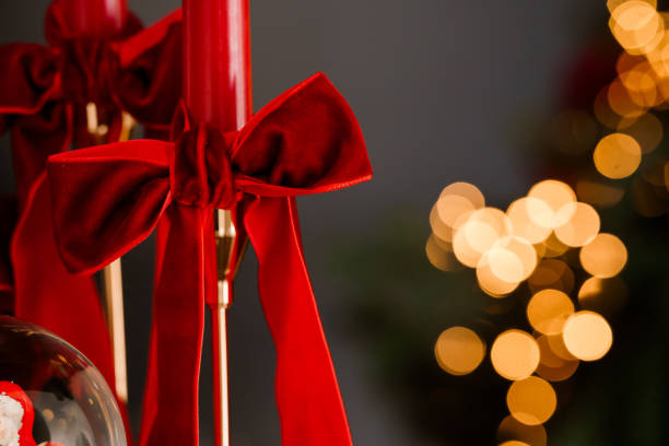 Elegant Red Velvet Bows with Christmas Lights Background.