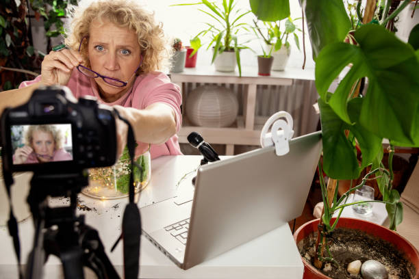 istock Mature Woman influencer preparing camera for filming 2183324401
