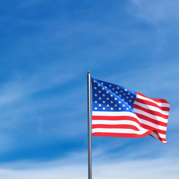 istock American flag waving in blue sky. 2183324797