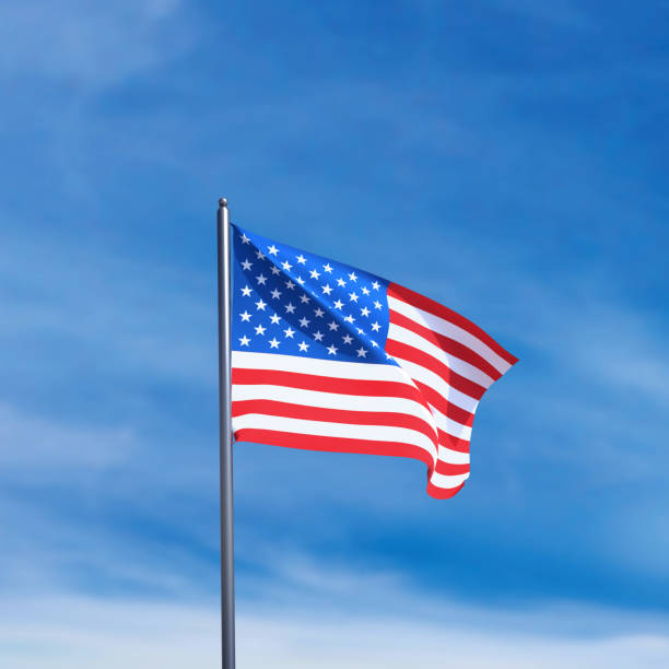 istock American flag waving in blue sky. 2183324803