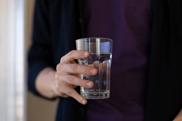 istock Unknown man with glass of water in hand 2183325858