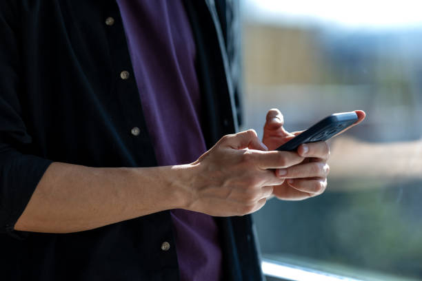 istock Close-up of unknown man texting on phone 2183325859
