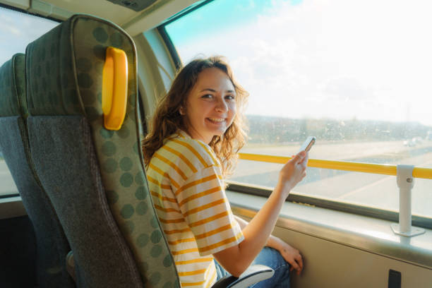 istock Woman using smartphone traveling by bus on sunny day 2183325990