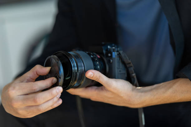 Unknown man prepares his camera for a photo shoot