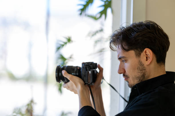 istock Young man takes photos with mirrorless camera 2183326904