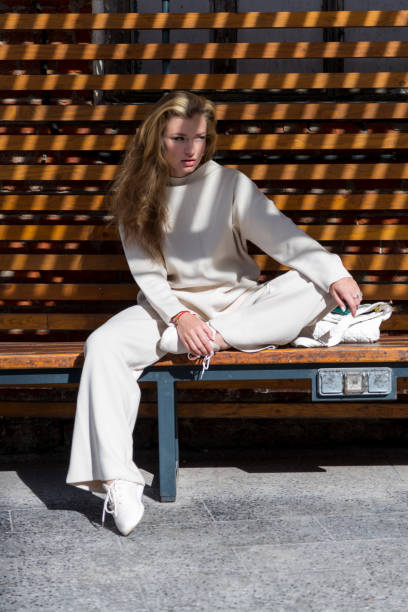 istock Women sits on bench in sunny day 2183330503