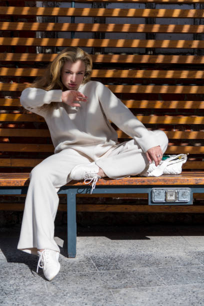 istock Women sits on bench in sunny day 2183330681