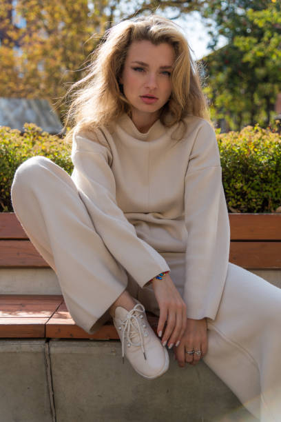 istock Beautiful women sits on bench 2183333330