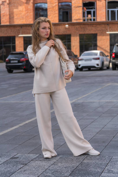 istock Woman in white stands on parking 2183335035