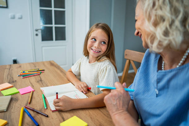 istock Girl studying at home with her grandma 2183335102