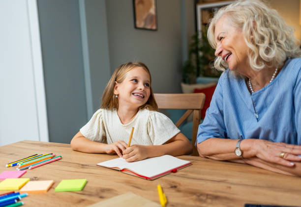 istock Grandmother and granddaughter doing homework together 2183336012