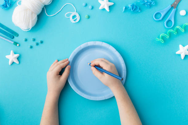 istock Snowflake made from wool threads on blue paper plate Christmas ideas for kindergarten diy 2183339290