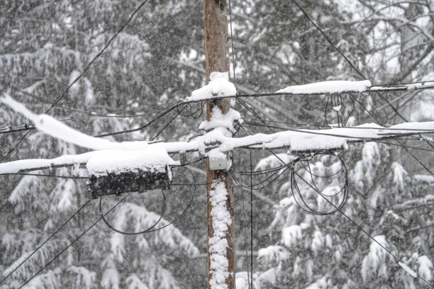 istock Utility pole and wires covered with snow in blizzard 2183340229