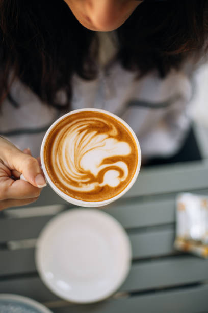 woman holding a cup of latte