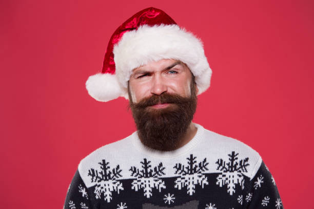istock Handsome Santa. Bearded hipster looking confident Santa claus hat. Winter holidays. Naughty. Brutal attractive Santa long beard face close up. Fashionable man. Merry christmas. Daring to congratulate 2183343708