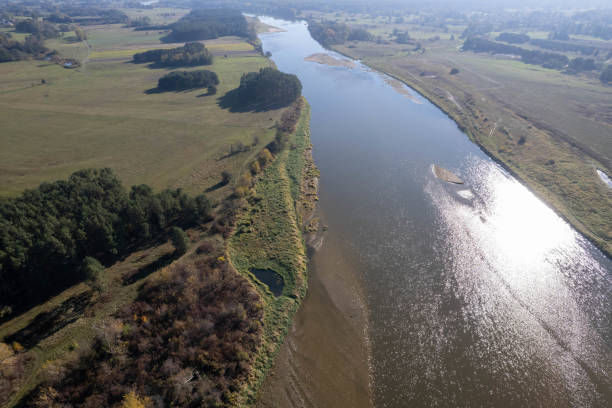 istock Unregulated plot of land on the Bug River in eastern Poland in Podlasie, surrounded by pastures and forest, autumn, cloudless sky 2183345410
