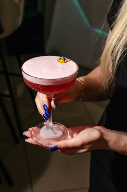 istock A woman's hand holds a cocktail 2183345886