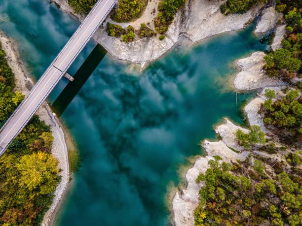 istock Aerial view of bridge over turquoise river and lush greenery 2183349799