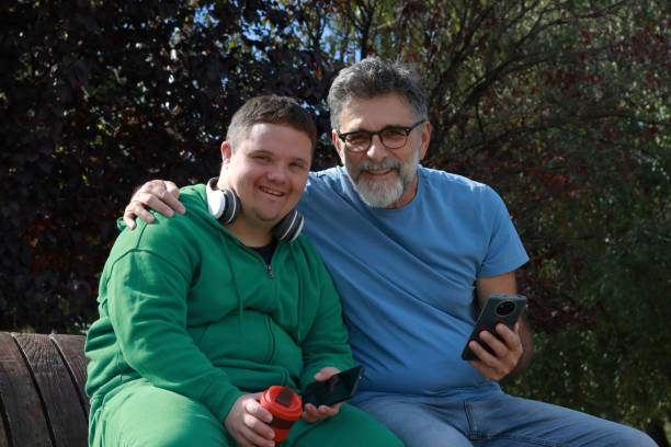 istock Father and son with Down syndrome enjoy in sunny day 2183355528