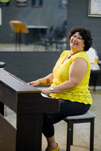istock female pianist sitting while smiling and playing her instrument 2183355614