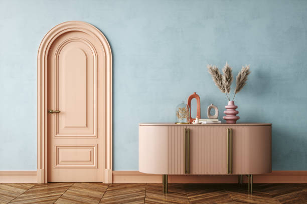 Pastel-Toned Minimalist Interior with Arched Door and Modern Sideboard A minimalist interior setup featuring a soft pastel pink arched door and matching sideboard against a light blue wall.
The sideboard is decorated with modern ceramic vases, dried pampas grass, and sculptural accents.
The herringbone wood floor complements the soft colors, giving the room a balanced and cohesive look. art deco vase stock pictures, royalty-free photos & images