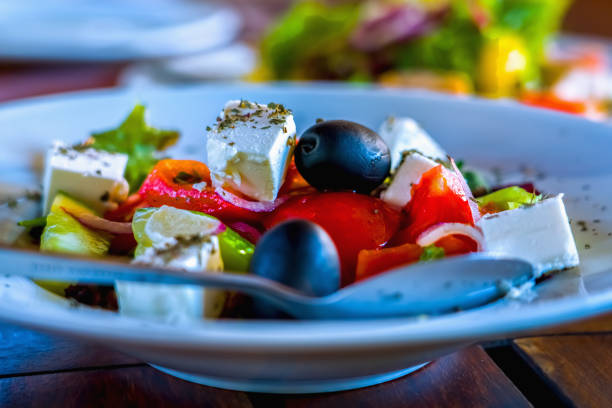 istock Close up tasty fresh salad with vegetables on white plate. Horizontal image. 2183360041