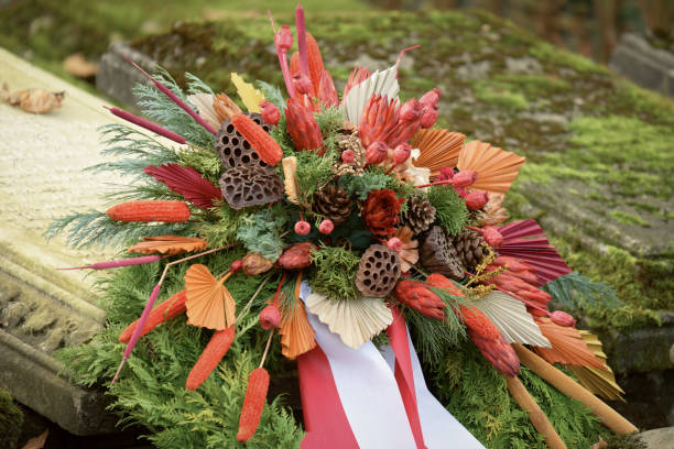 istock autumnal funeral arrangement at grave 2183360750