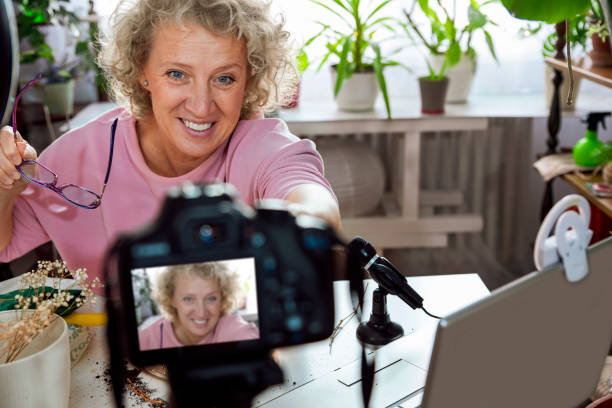 istock Mature Woman influencer preparing camera for filming 2183362289